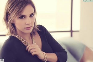 A close up of a woman with a ring on her finger.
