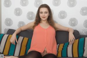 A woman in a black lingerie posing on a bed.