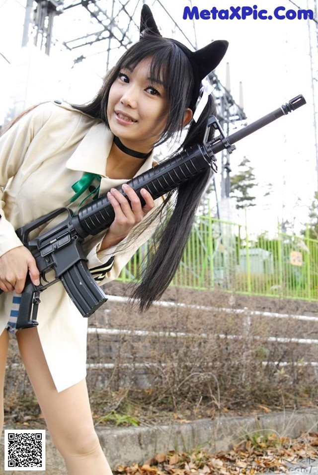 A woman in a cat costume holding a rifle.