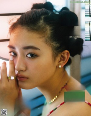 A magazine spread with a woman holding a camera.