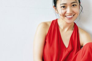 A magazine with a smiling woman on the cover.