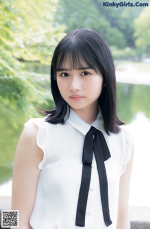 A young woman with long black hair is posing for a picture.
