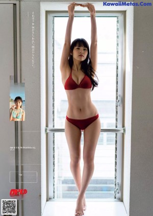 A woman in a white bikini posing for a picture.