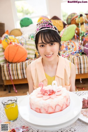 A woman sitting at a table with a plate of food.