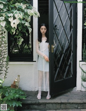 A magazine page with a picture of a woman with long black hair.