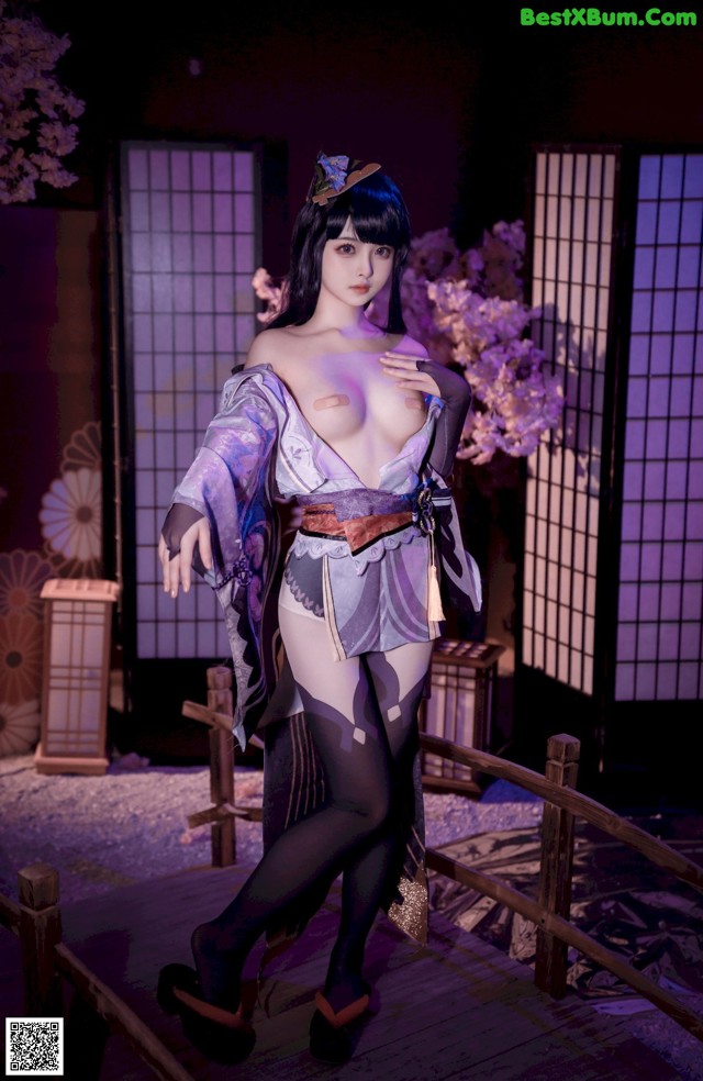 A woman in a kimono is posing for a picture.