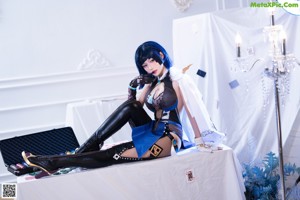 A woman sitting on top of a bed covered in playing cards.