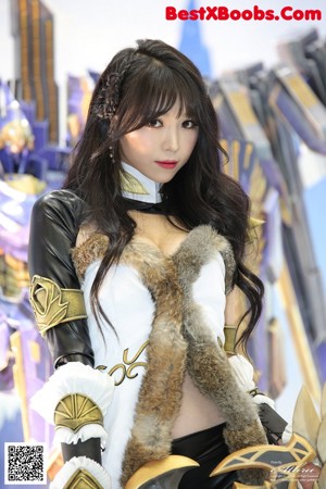 A woman dressed in a costume standing in front of a screen.